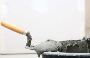 Trowel on a bucket filled with concrete mix | EasyMix Concrete