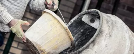 Cement being poured into a mixer | EasyMix Concrete